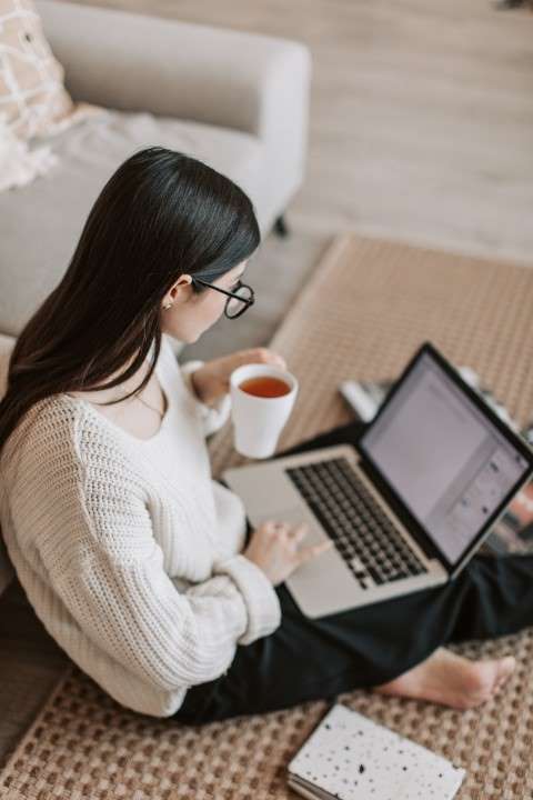young-woman-researching-on-laptop-conventional-mortgage-loan